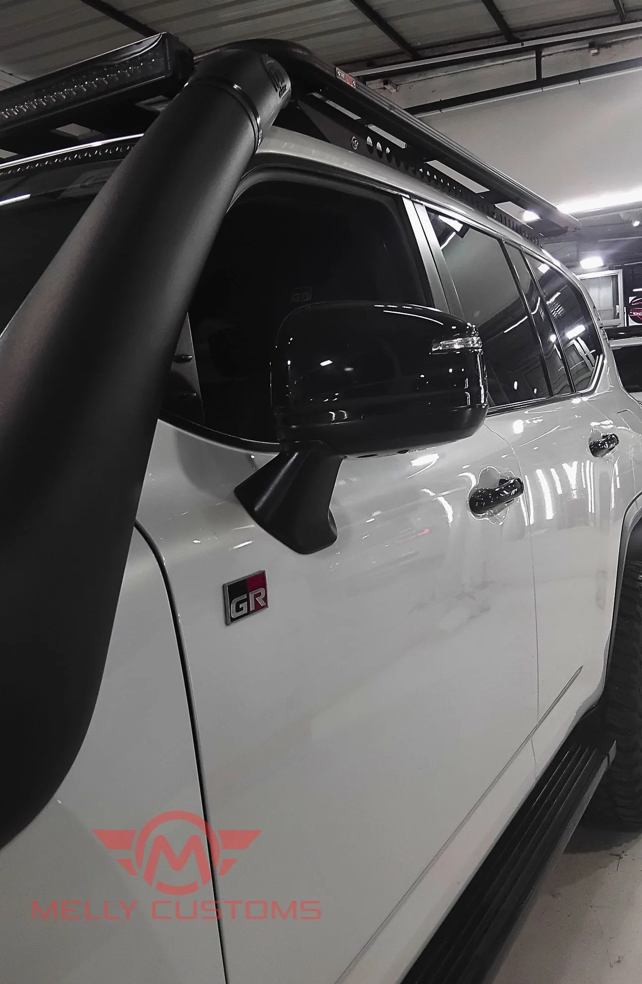 Side profile of a white Toyota Land Cruiser after paint protection film